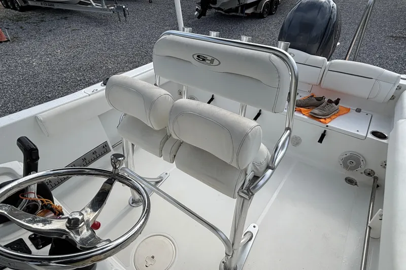 Slide: The Image of 2016 Sea Hunt Ultra 225 boat interior with steering wheel and seating. - 19