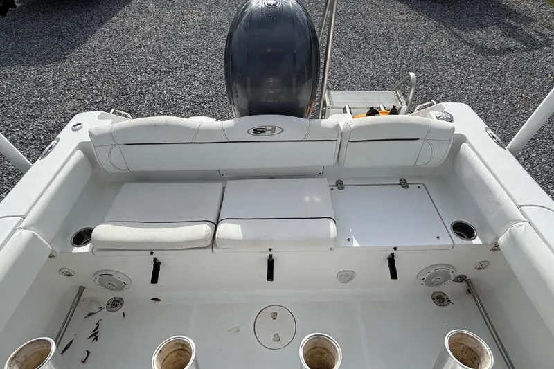 Slide: The Image of 2016 Sea Hunt Ultra 225 boat interior with seating and engine view. - 20