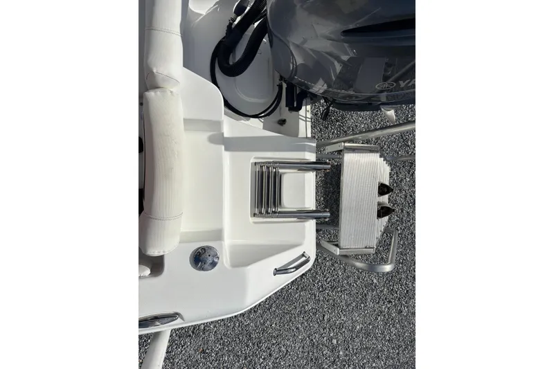 Slide: The Image of 2016 Sea Hunt Ultra 225 boat stern with ladder and engine detail. - 24