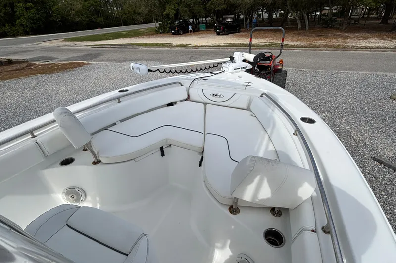 Slide: The Image of 2016 Sea Hunt Ultra 225 boat interior with white seating and steering console. - 4