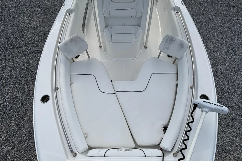 Slide: The Image of 2016 Sea Hunt Ultra 225 boat interior with white seating and Minn Kota trolling motor. - 7