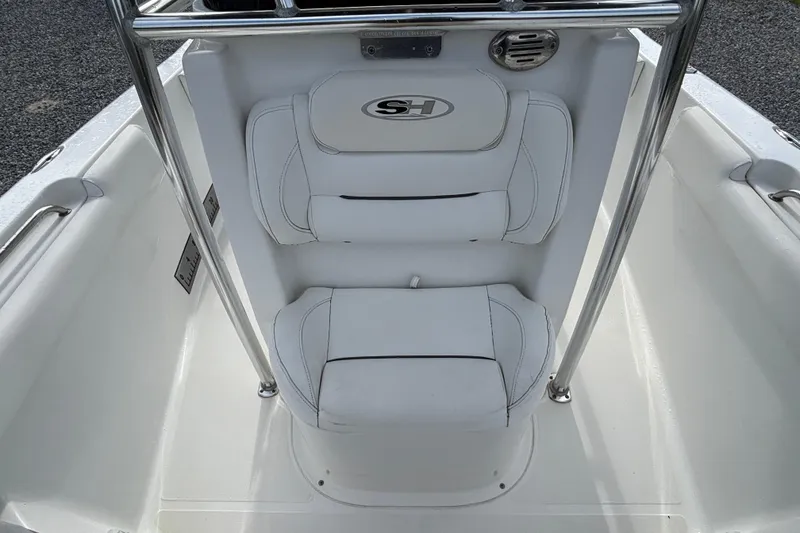 Slide: The Image of 2016 Sea Hunt Ultra 225 boat seating with white cushions and stainless steel rails. - 9