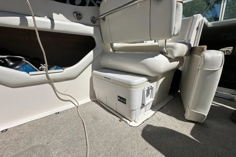 Slide: The Image of Interior of a 1998 Sea Ray 215 Express Cruiser with seating and storage. - 12
