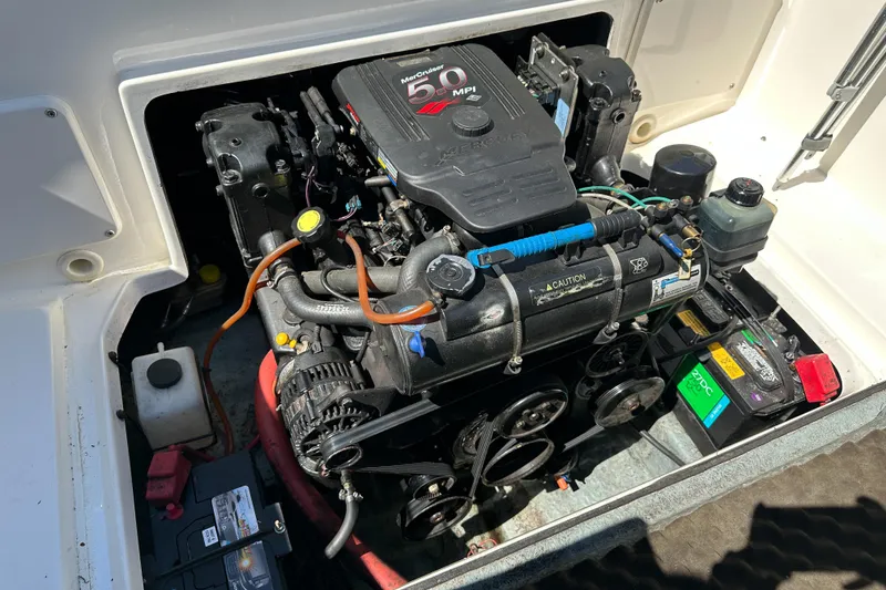 Slide: The Image of Engine compartment of a 1998 Sea Ray 215 Express Cruiser with visible components. - 15