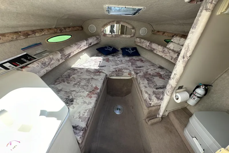 Slide: The Image of Interior of a 1998 Sea Ray 215 Express Cruiser cabin with seating and amenities. - 20