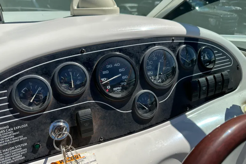 Slide: The Image of Dashboard of a 1998 Sea Ray 215 Express Cruiser with gauges and controls. - 24