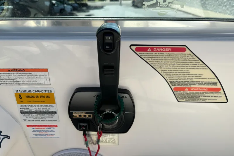 Slide: The Image of Control panel of a 1998 Sea Ray 215 Express Cruiser with safety warnings and capacity limits. - 26