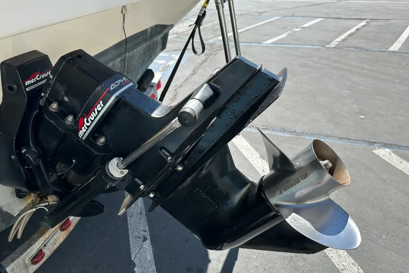 Slide: The Image of 1998 Sea Ray 215 Express Cruiser with MerCruiser Alpha One outdrive in parking lot. - 5