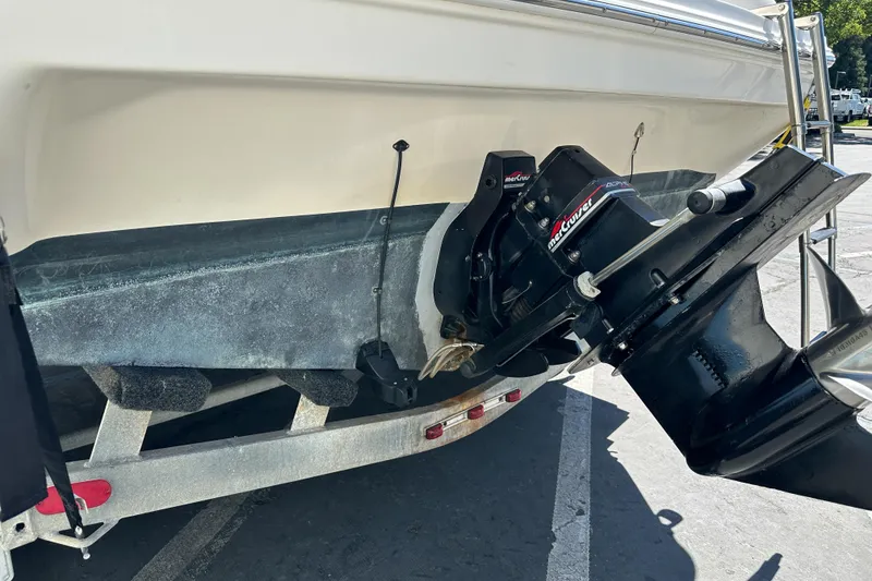 Slide: The Image of 1998 Sea Ray 215 Express Cruiser boat on trailer, featuring MerCruiser outdrive. - 6