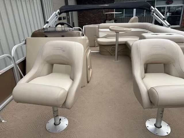 Slide: The Image of Interior of a 2012 Bennington 20 SF pontoon boat with beige seating. - 10