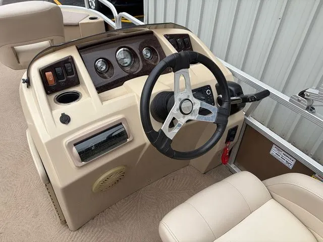 Slide: The Image of 2012 Bennington 20 SF boat helm with steering wheel and gauges. - 14