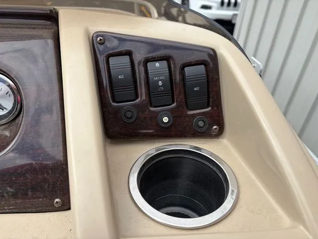 Slide: The Image of Dashboard of a 2012 Bennington 20 SF with switches and cup holder. - 17