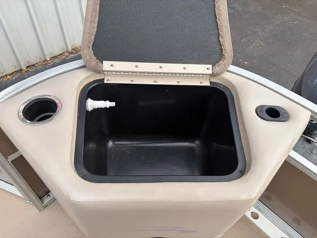 Slide: The Image of 2012 Bennington 20 SF boat with open storage compartment and cup holder. - 26