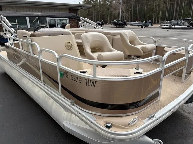 Slide: The Image of 2012 Bennington 20 SF pontoon boat with beige seats on parking lot. - 4
