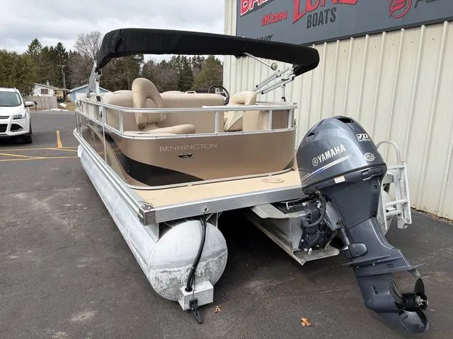 Slide: The Image of 2012 Bennington 20 SF pontoon boat with Yamaha motor, parked outside a building. - 6