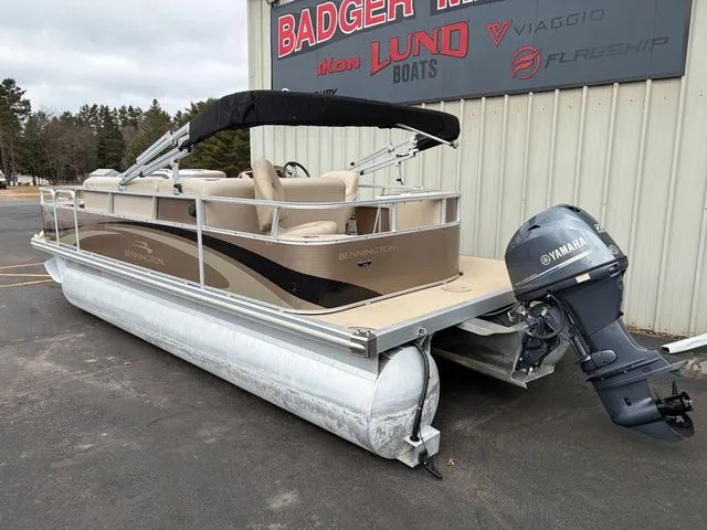Slide: The Image of 2012 Bennington 20 SF pontoon boat with Yamaha motor in front of boat building. - 7