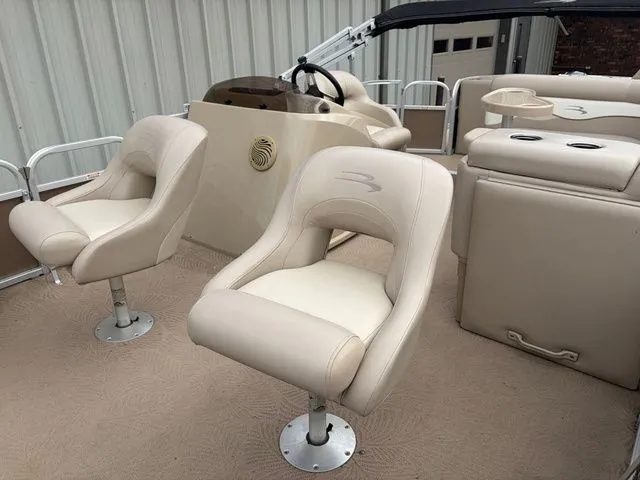 Slide: The Image of Interior of a 2012 Bennington 20 SF pontoon boat with beige seats. - 9