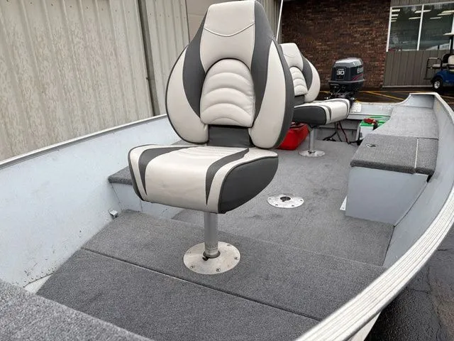 Slide: The Image of Interior of a 1997 Lund 14 Rebel boat with cushioned seats. - 11