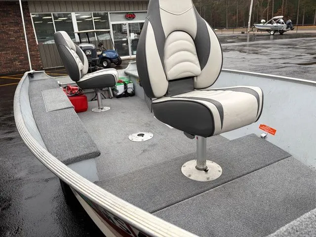Slide: The Image of Interior of a 1997 Lund 14 Rebel boat with cushioned seats. - 12