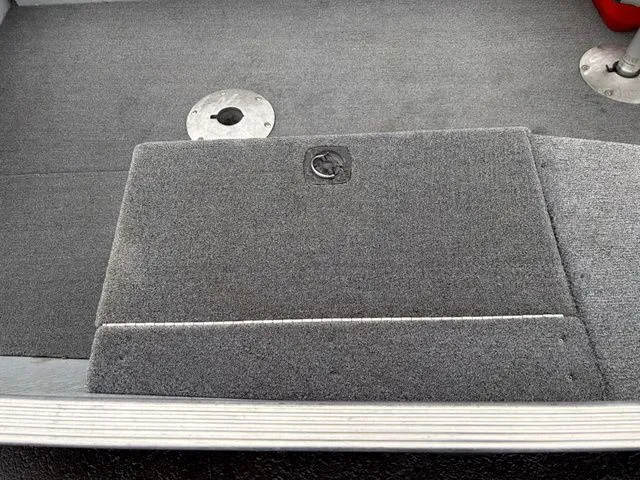 Slide: The Image of Interior of a 1997 Lund 14 Rebel boat with gray carpet flooring. - 16