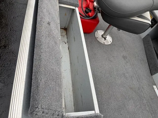 Slide: The Image of Interior of a 1997 Lund 14 Rebel boat with storage compartment and seat. - 17