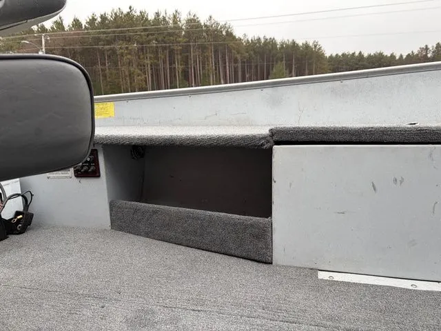 Slide: The Image of Interior of a 1997 Lund 14 Rebel boat with gray carpeting. - 19