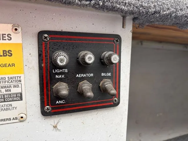 Slide: The Image of Control panel of a 1997 Lund 14 Rebel boat with switches for lights, aerator, and bilge. - 20