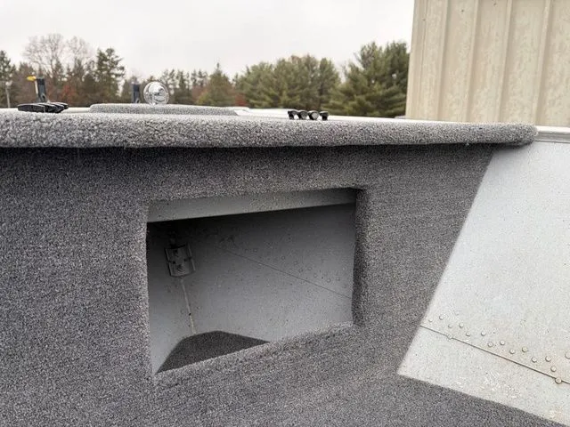 Slide: The Image of Interior view of a 1997 Lund 14 Rebel boat with gray carpeting. - 23