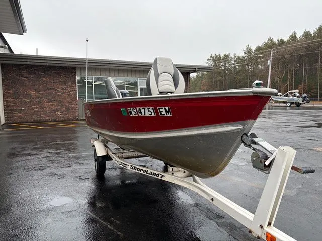Slide: The Image of Red 1997 Lund 14 Rebel boat on trailer, rainy parking lot. - 4