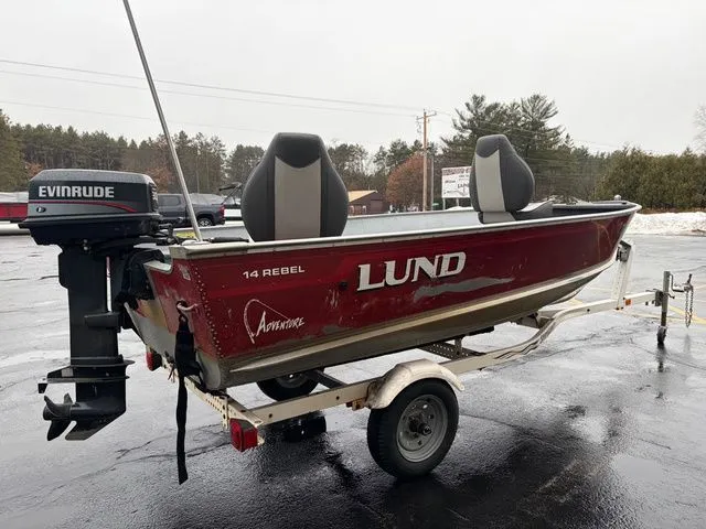 Slide: The Image of 1997 Lund 14 Rebel boat with Evinrude motor on trailer. - 6