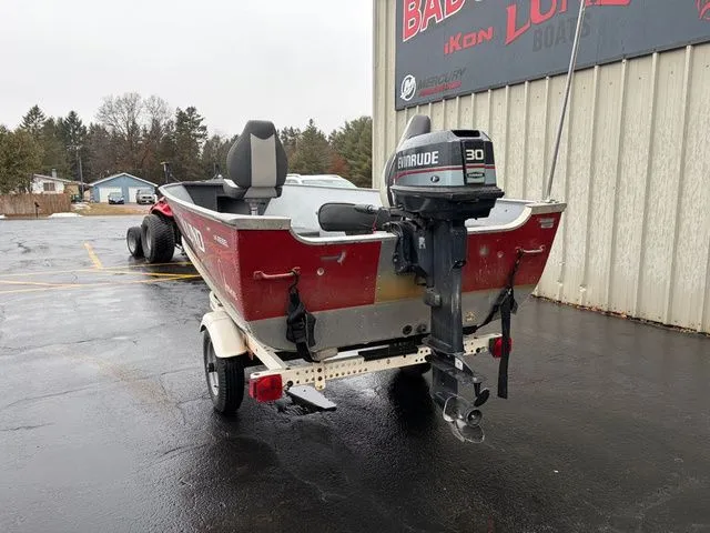 Slide: The Image of Red 1997 Lund 14 Rebel boat with Evinrude 30 motor on trailer. - 8