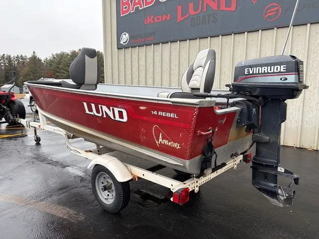 Slide: The Image of 1997 Lund 14 Rebel boat with Evinrude motor on trailer. - 9