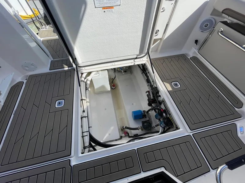 Slide: The Image of 2023 Cutwater C-288 boat engine compartment with open hatch and clean deck. - 23