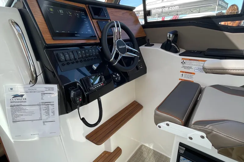 Slide: The Image of 2023 Cutwater C-288 boat helm with modern controls, touchscreen display, and comfortable seating. - 31