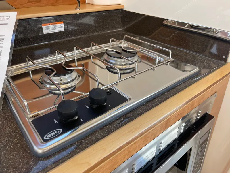 Slide: The Image of 2023 Cutwater C-288 boat kitchen with a two-burner stove and oven. - 37