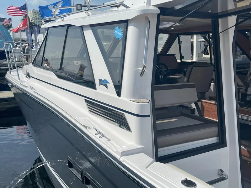 Slide: The Image of 2023 Cutwater C-288 boat docked, side view showing cabin and seating area. - 5