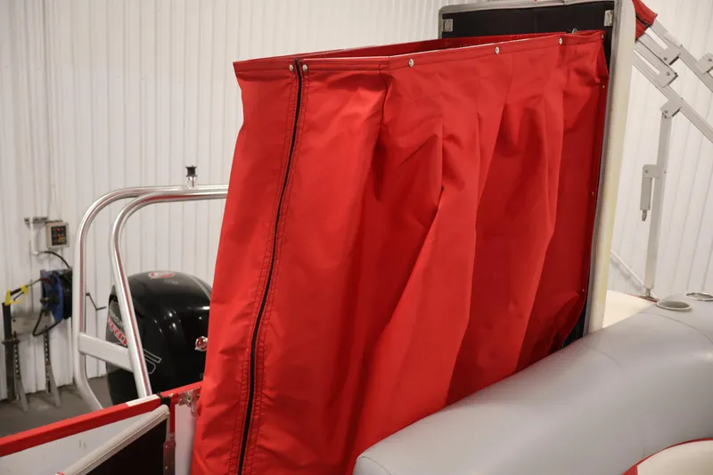 Slide: The Image of 2019 Bentley Pontoons 200 CRUISE with red privacy curtain and motor in a garage. - 29