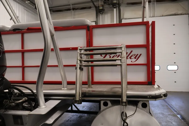 Slide: The Image of 2019 Bentley Pontoons 200 CRUISE with red accents and stainless steel ladder in a garage. - 31