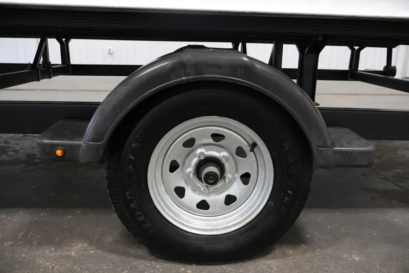 Slide: The Image of Trailer wheel of a 2019 Bentley Pontoons 200 CRUISE, featuring a sturdy tire and fender. - 40