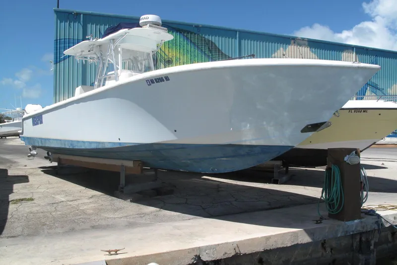 The Image of 2017 SeaVee 340B boat on dry dock, blue hull, marina background. - 0