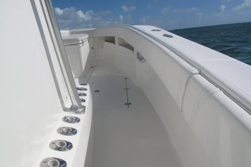 Slide: The Image of 2017 SeaVee 340B boat deck with rod holders, ocean view, and clear sky. - 10