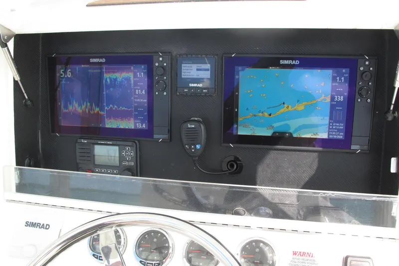 Slide: The Image of 2017 SeaVee 340B boat dashboard with Simrad navigation and communication equipment. - 15