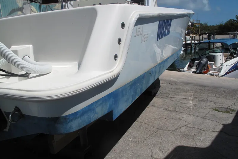 Slide: The Image of 2017 SeaVee 340B boat docked, showcasing sleek design and white hull. - 18
