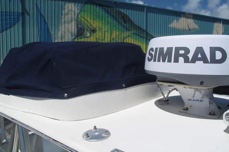 Slide: The Image of 2017 SeaVee 340B boat with Simrad radar, docked near colorful mural. - 20