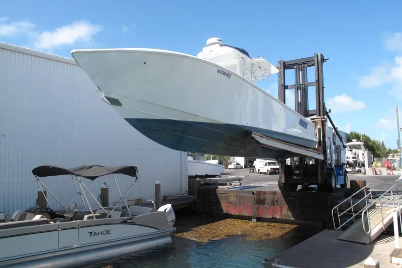 Slide: The Image of 2017 SeaVee 340B boat being lifted by a forklift at a marina. - 27