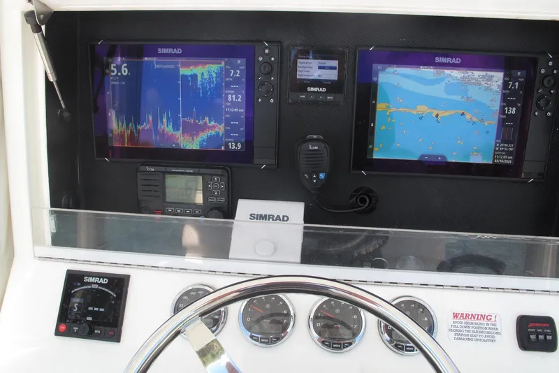 Slide: The Image of 2017 SeaVee 340B boat dashboard with Simrad navigation and control systems. - 28