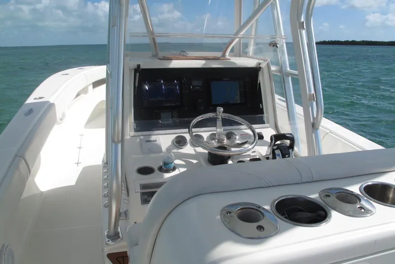 Slide: The Image of 2017 SeaVee 340B boat cockpit with steering wheel and navigation equipment on open water. - 4
