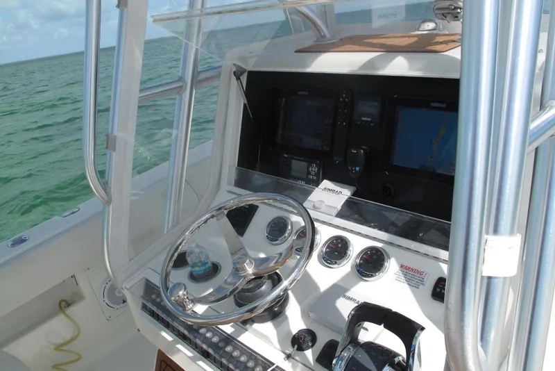 Slide: The Image of 2017 SeaVee 340B boat helm with navigation screens and steering wheel. - 9