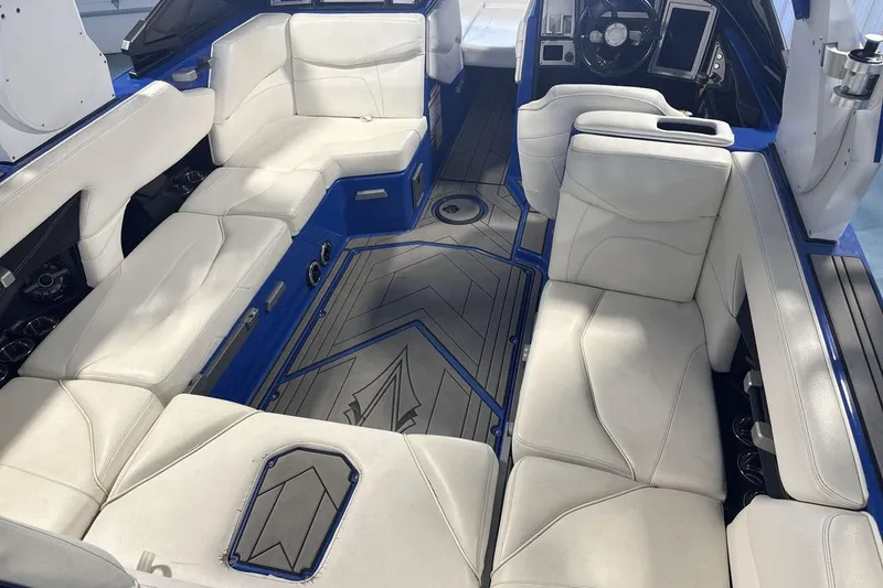 Slide: The Image of Luxurious interior of 2019 Supra SA 550 boat with white seating and blue accents. - 10