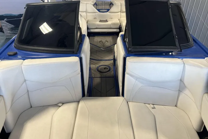 Slide: The Image of 2019 Supra SA 550 boat interior with white seating and blue accents. - 12